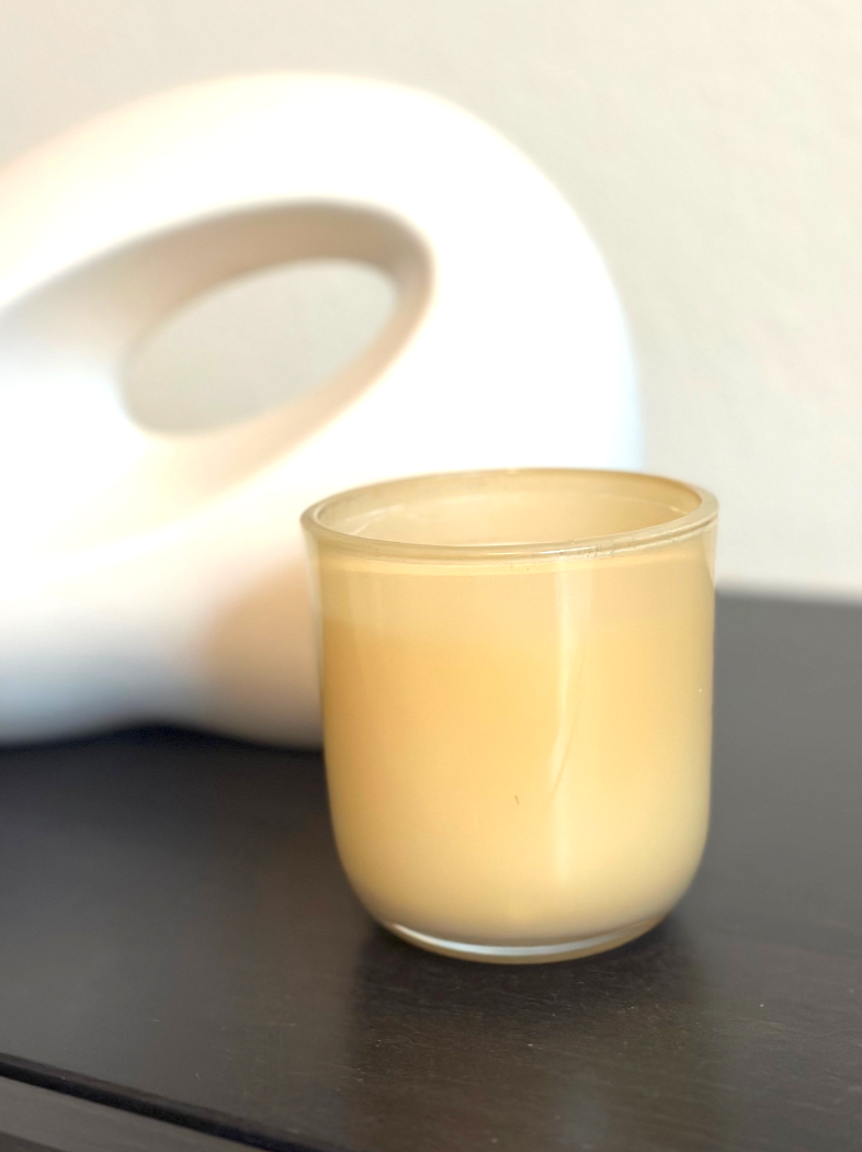 Minimal candle on a desk representing a thoughtful, long-lasting professional gift
