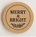 Round wooden sign with 'Merry & Bright' text and leaf design on a light background