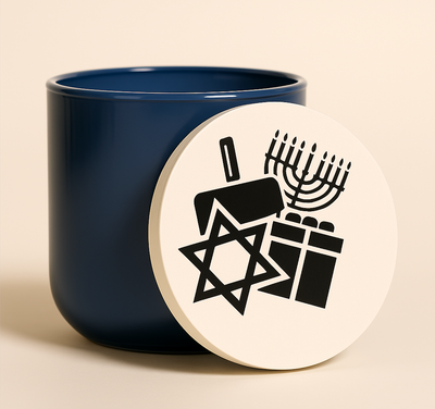 Hanukkah message candle in cobalt blue glass with engraved wood lid featuring menorah and dreidel symbols.