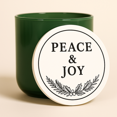 Green candle with a wooden coaster labeled 'Peace & Joy' for Christmas and holiday gift. giving and decorating 